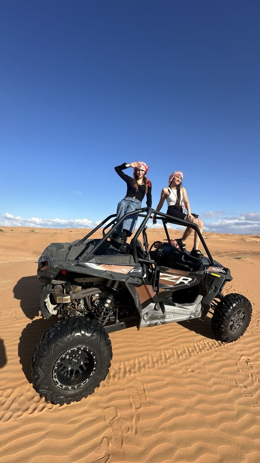 Guests with a dune buggy in the Dubai desert