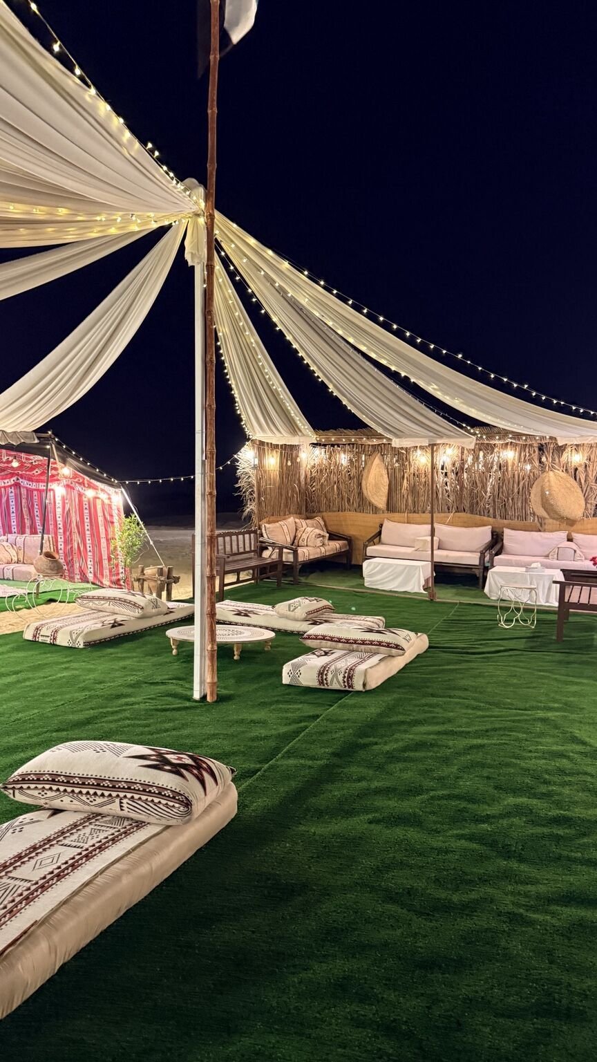 Canopy lights and lounge seating at the private desert camp