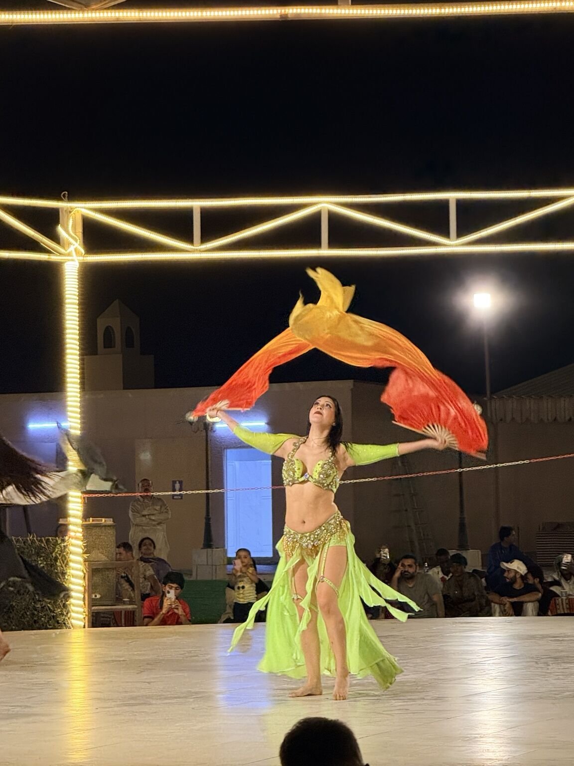 Live belly dance performance at the desert safari camp