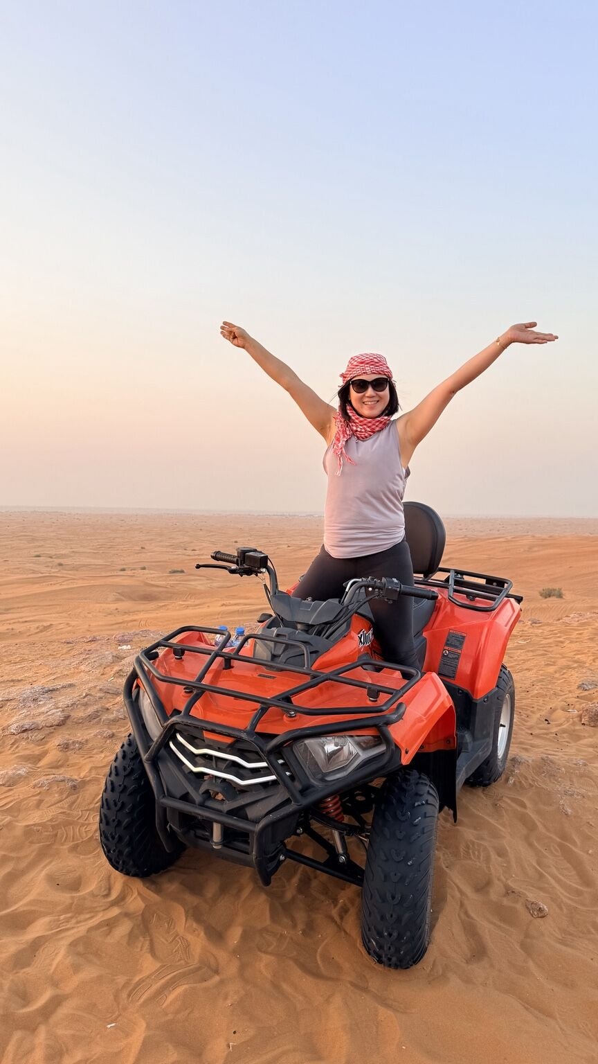 Guest enjoying a quad bike at sunset in the Dubai desert